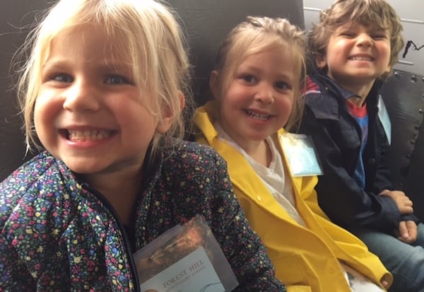 Students smiling on bus