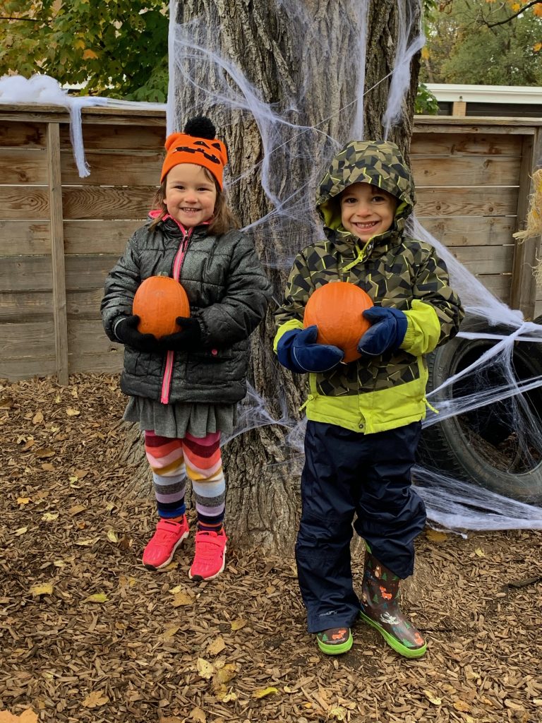 Two students with pumpkins