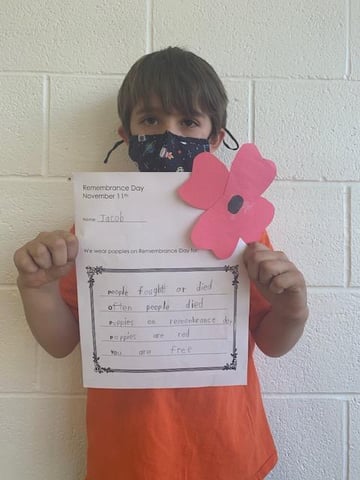 Student with Poem in honour of Remembrance Day