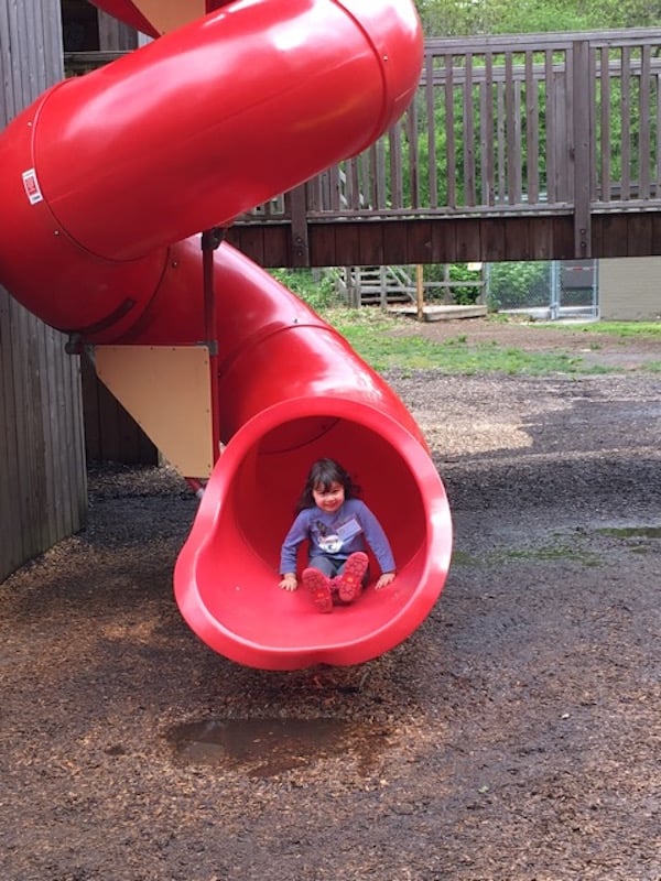 Student smiling at bottom of a slide