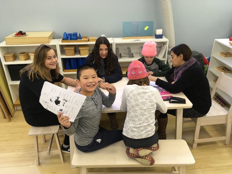 Students and teachers at a table