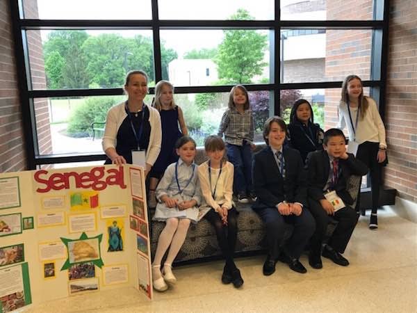 Group of students and Senegal Presentation board