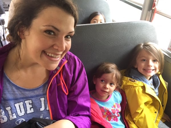 Teacher and Students smiling on a bus