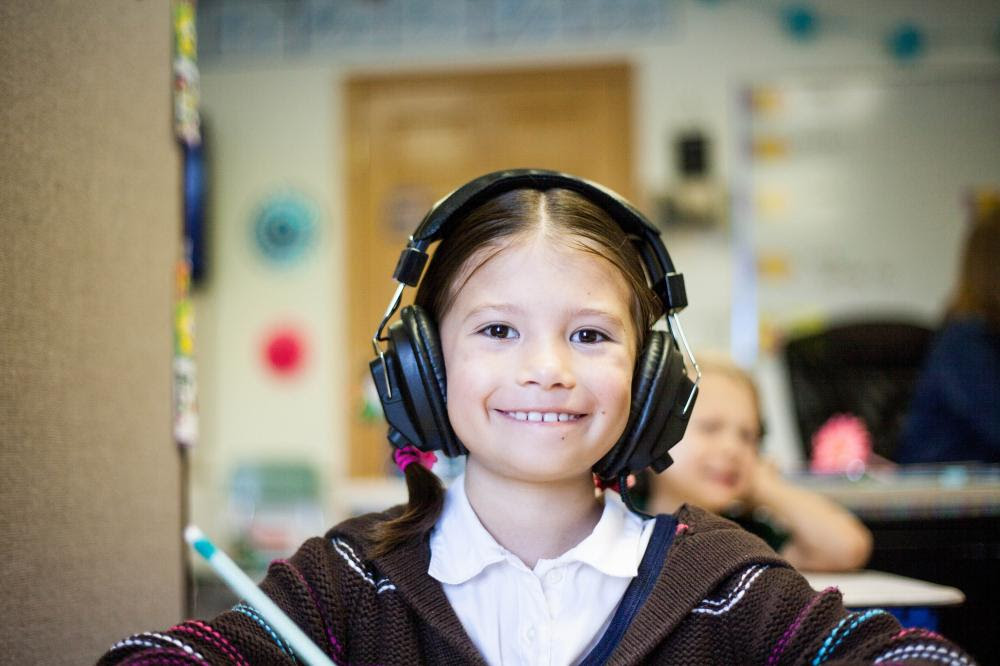 Stock Image of Child smiling with headphones on