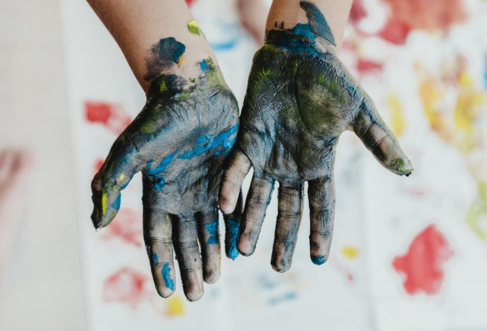 Hands covered in paint