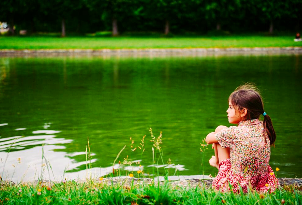 Stock image of child at a pond