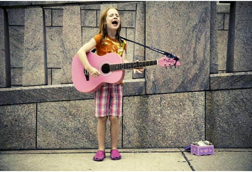 Child with guitar, busking