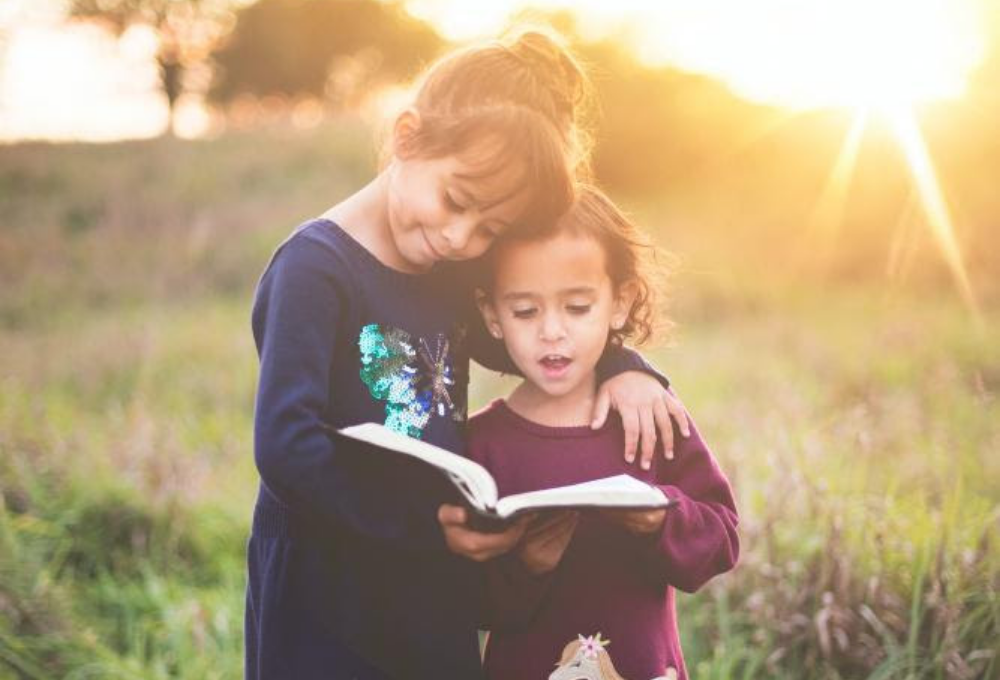 2 Children with a book