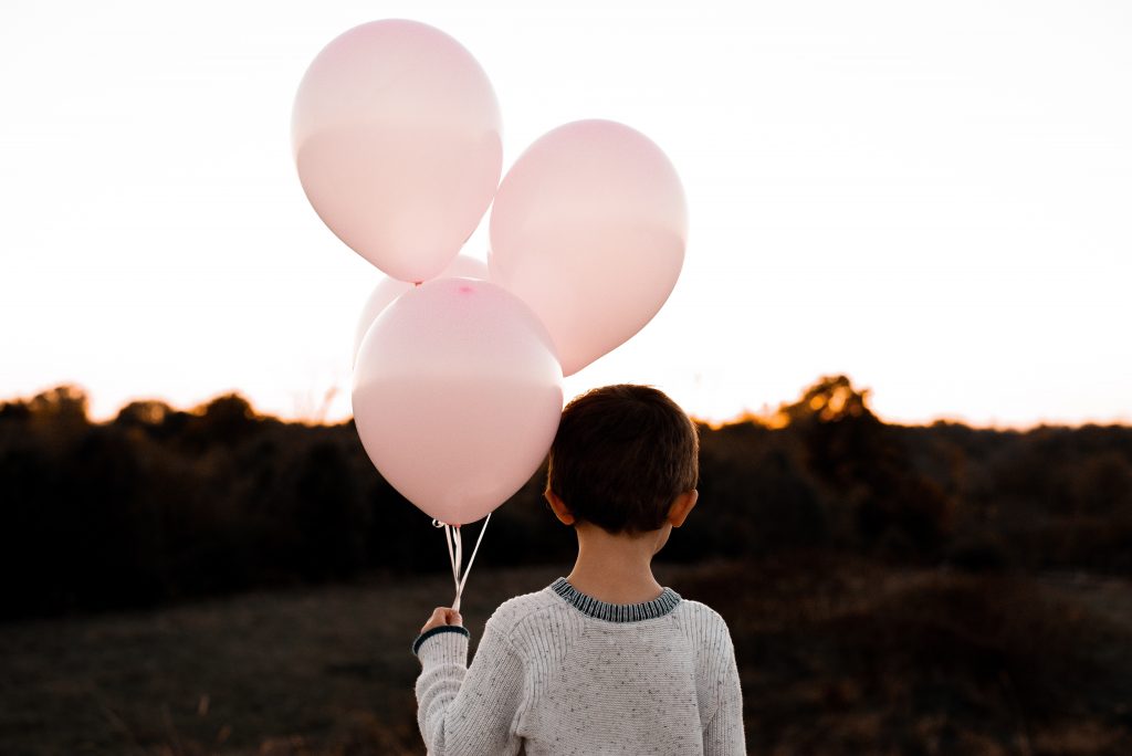 Child with pink balloons
